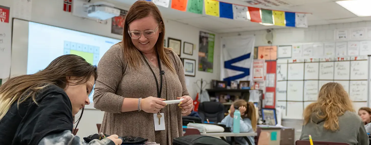 Students receiving guidance in a classroom setting.